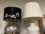 two lamps that are on a shelf next to a picture