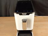 an image of a coffee maker sitting on top of a wooden table