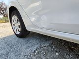 a white car that is parked on the side of the road