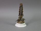 a clock that is sitting on top of a white pedestal