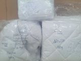 three rolls of toilet paper wrapped in plastic on top of a cardboard box