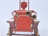 a red toy car that is sitting on a white surface