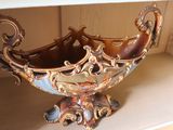 a decorative bowl sitting on a shelf in a room