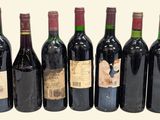 six bottles of red wine are lined up in a row