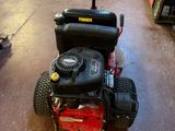 a small lawn mower sitting in a garage