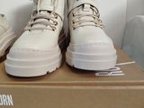 pair of white sneakers on a box on a white surface