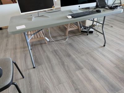 a desk with two computer monitors and a keyboard on it