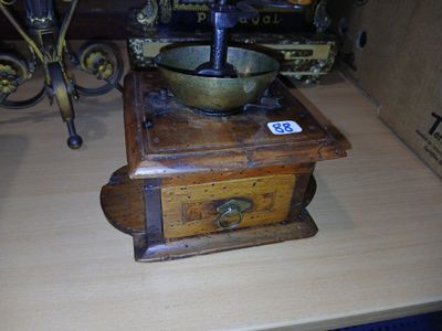 a wooden box with a metal bowl on top of it