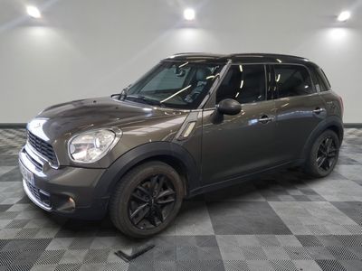 the mini countryman is parked in the garage on a checkered floor