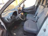 the interior of a small car with the door open and the driver ' s seat down