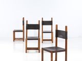 four chairs are lined up in a row on a white surface