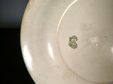 a white plate that has a brown design on it