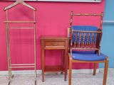 two chairs and a table in front of a pink wall