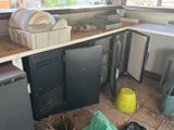 a dirty kitchen with a lot of trash on the floor