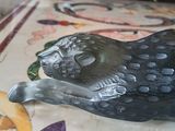 a figurine of a black cat on a table