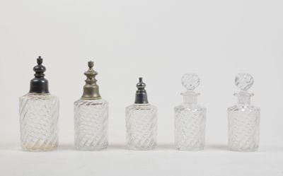 four glass bottles with silver tops and a silver stopper