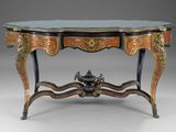 an ornately decorated console table with a glass top