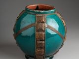 a green vase with a gold stripe around it