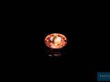 an image of an orange diamond in the dark