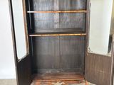 a wooden cabinet with a mirror on top of it