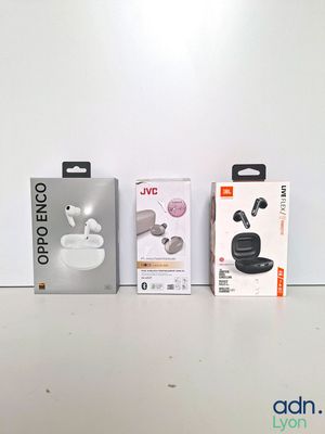 two boxes of earphones sitting next to each other on a table