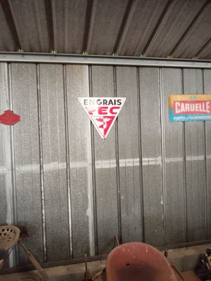 a fire hydrant in the corner of a garage with signs on the wall