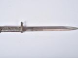 a knife that is laying on a white surface