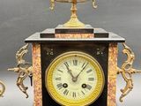 two clocks sitting next to each other on a table