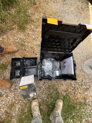 a person standing next to a tool box on the ground