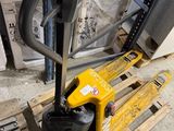 a fork lifter sitting on a pallet in a warehouse