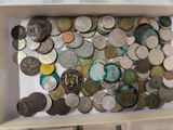 a lot of coins in a white box on a table