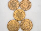 five different types of gold coins sitting on top of each other