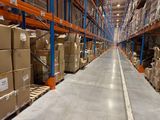 a long line of boxes on the floor in a warehouse