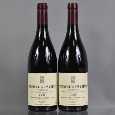 two bottles of wine sitting on top of a table next to each other