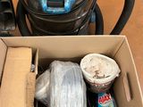 a box with a vacuum and other items inside of it