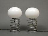 pair of white glass globe lamps on metal spring bases