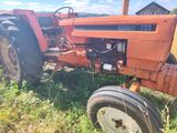an old tractor that is sitting in the grass