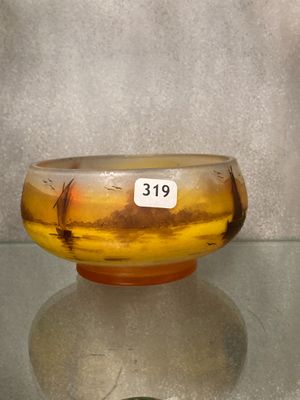 a glass bowl sitting on a table with a price tag on it