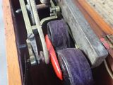 a wooden box with a pair of rollers inside of it