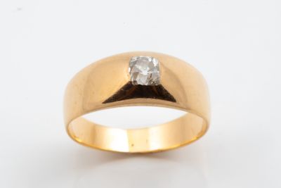 a close up of a gold ring with a diamond on it