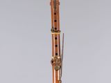 a close up of a musical instrument on a stand on a white surface