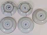 six blue and white plates with blue flowers on them on a white surface