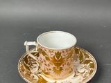 an image of a cup and saucer sitting on top of a table