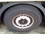 a close up of a flat tire on the side of a truck