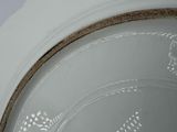 a close up of a white bowl with a brown rim