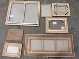 a lot of wood and glass pieces laid out on the ground