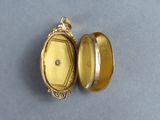 an image of a gold locke with a diamond in it