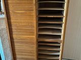 a wooden cabinet that has a lot of drawers inside of it