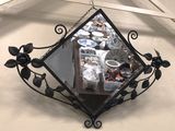 a mirror hanging on the wall with a bunch of dishes