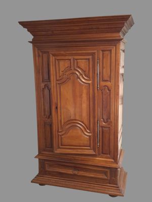 a wooden armoire with a clock on top of it